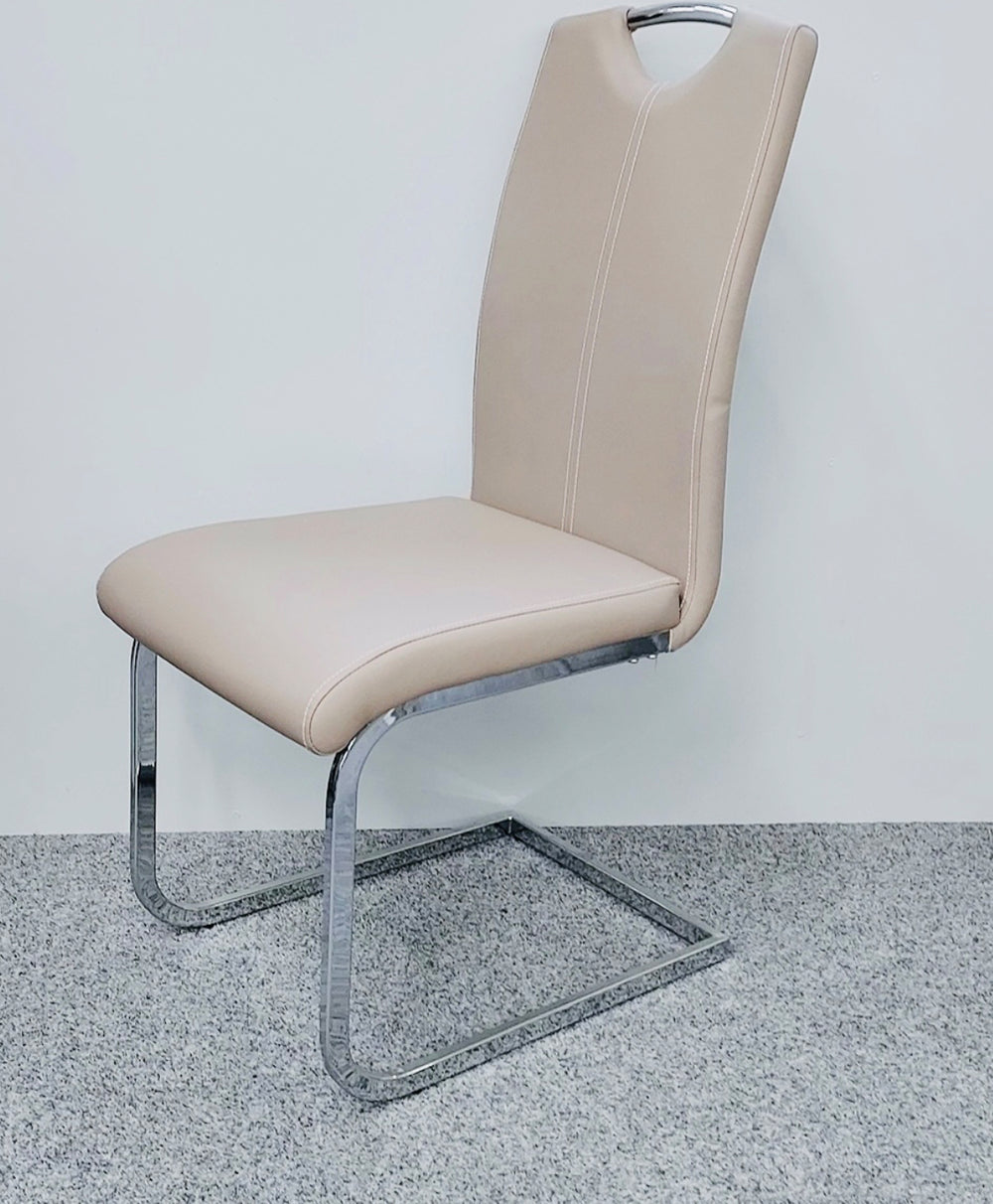 Beige chair with a metal frame on a gray floor and white wall background