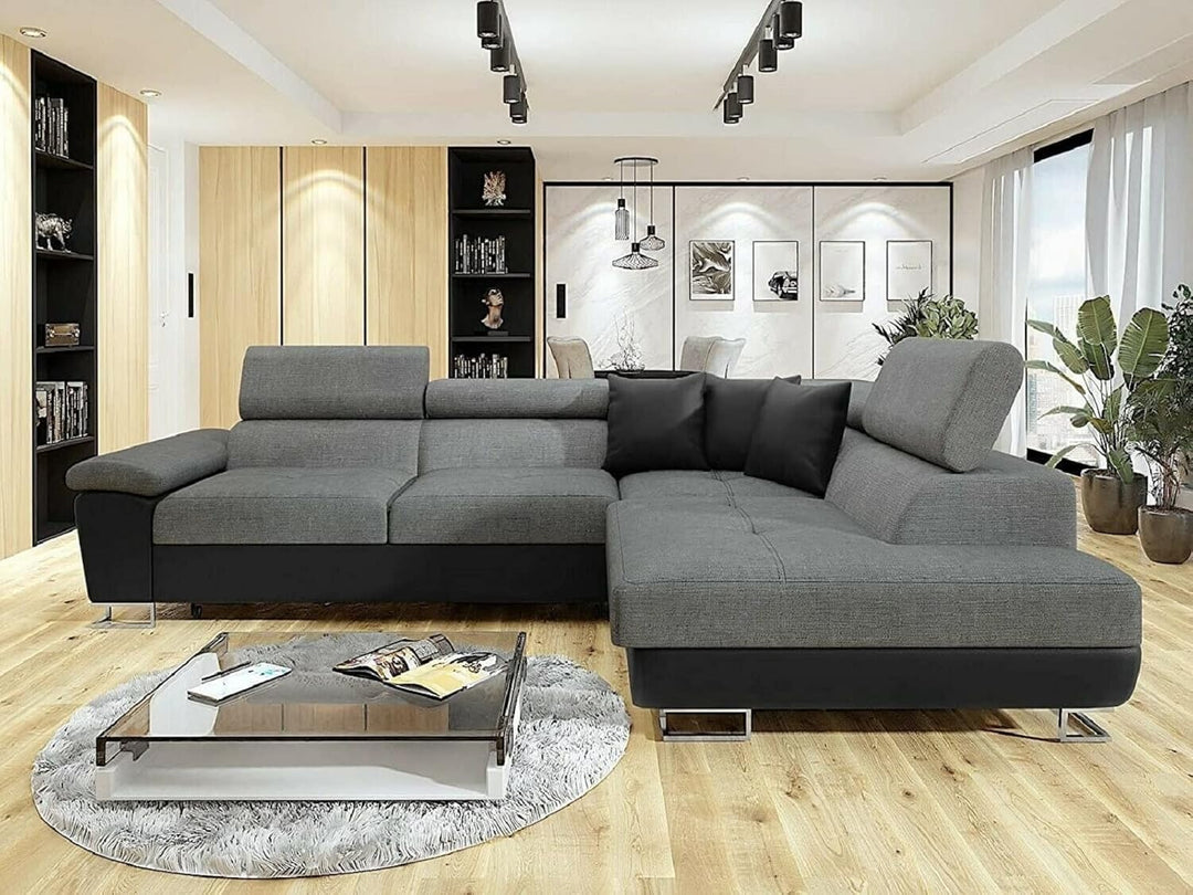 Modern living room with a gray sectional sofa, coffee table, and decorative elements.