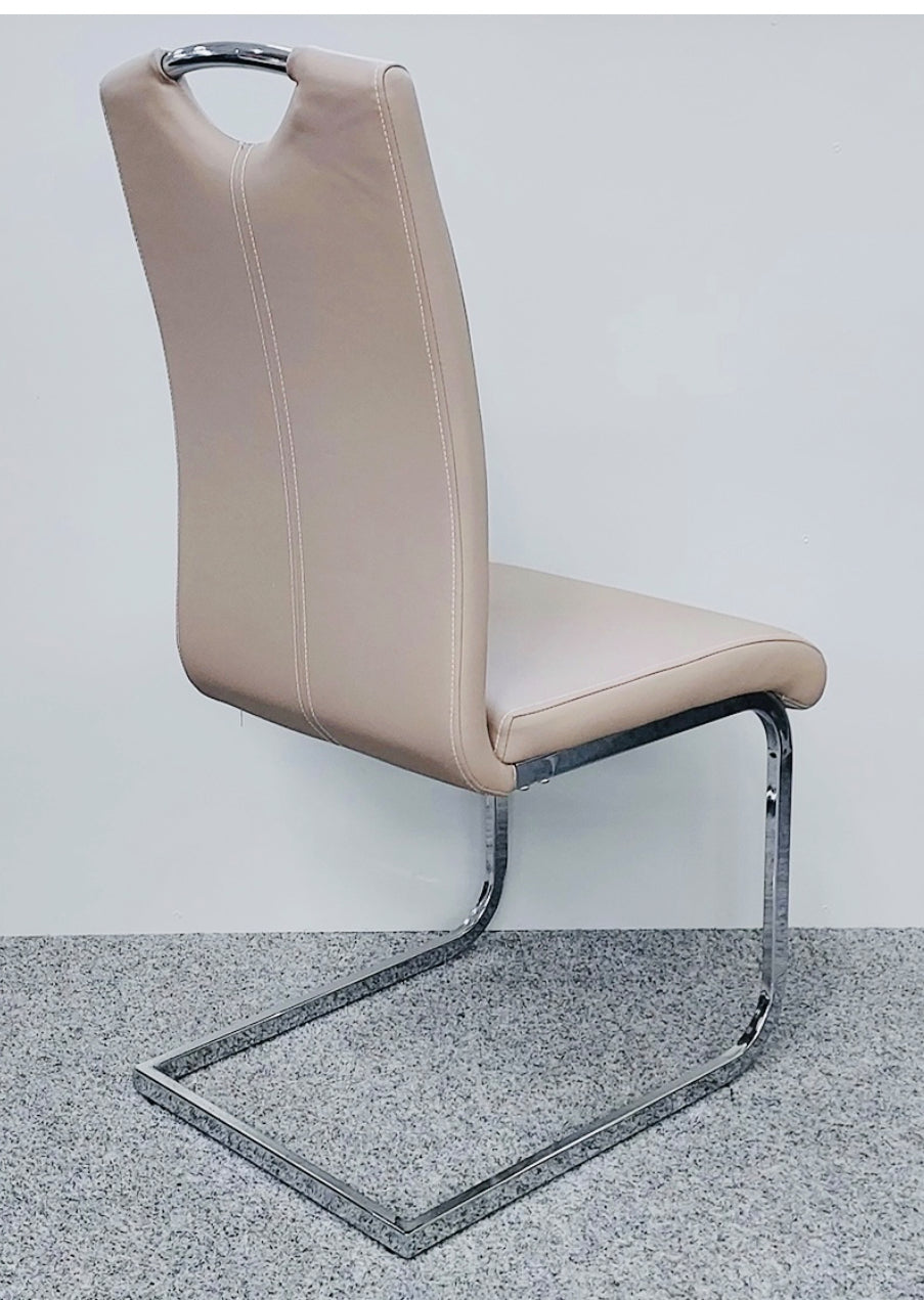 Beige chair with a metal frame on a gray surface