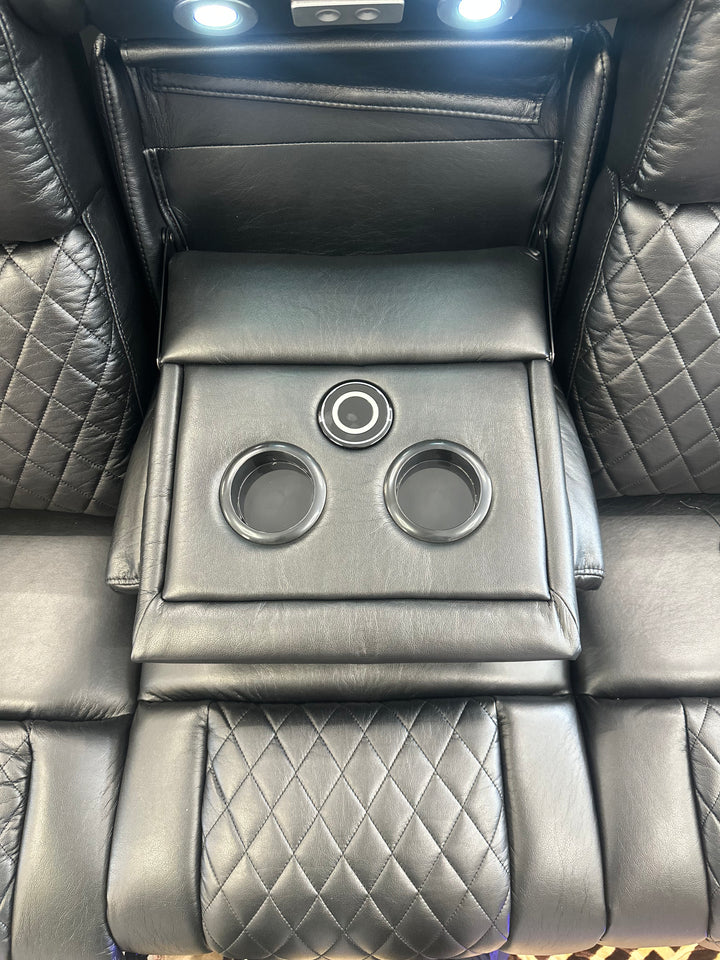 Luxury car interior with quilted leather seats and cup holders.