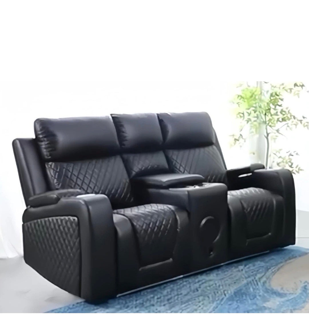 Black leather recliner sofa in a room with a rug and plant- 2 Seater Electric Recliner Sofa with Speaker 