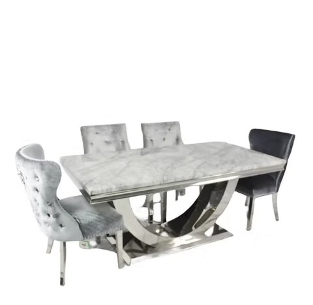 Dining table set with marble-like surface and modern chairs on a white background