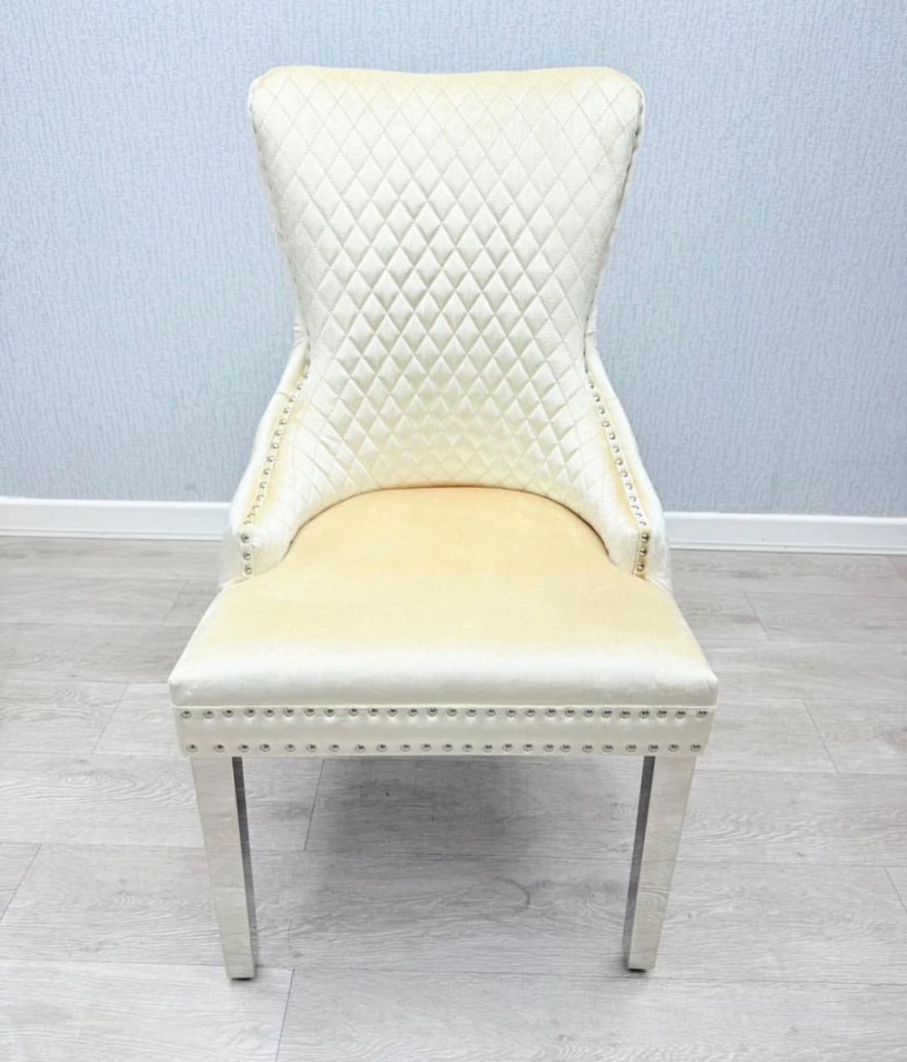 White chair with quilted backrest and yellow cushion on a light wooden floor.