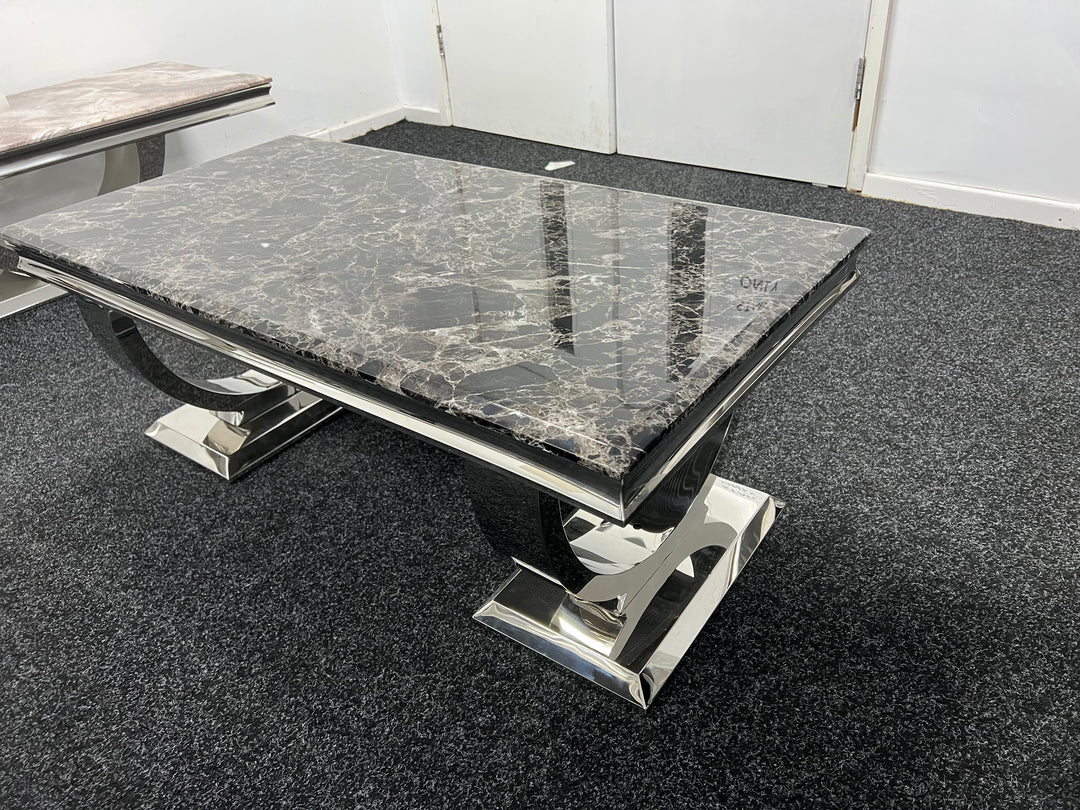 A back marble coffee table with a chrome leg