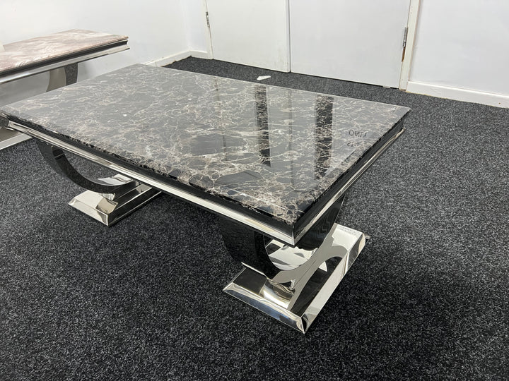 A back marble coffee table with a chrome leg