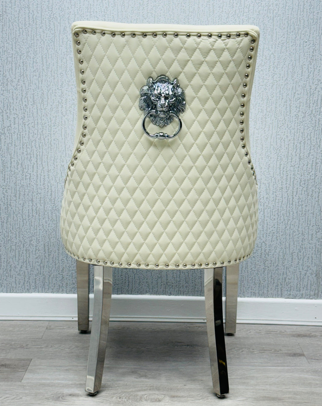  a cream color lion konker chair with chrome colour leg