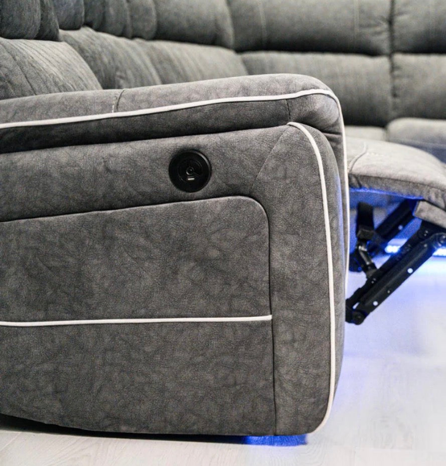 Gray recliner sofa with control panel on a white background