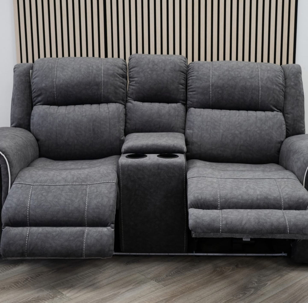 Gray sectional sofa with cup holders on a wooden floor.