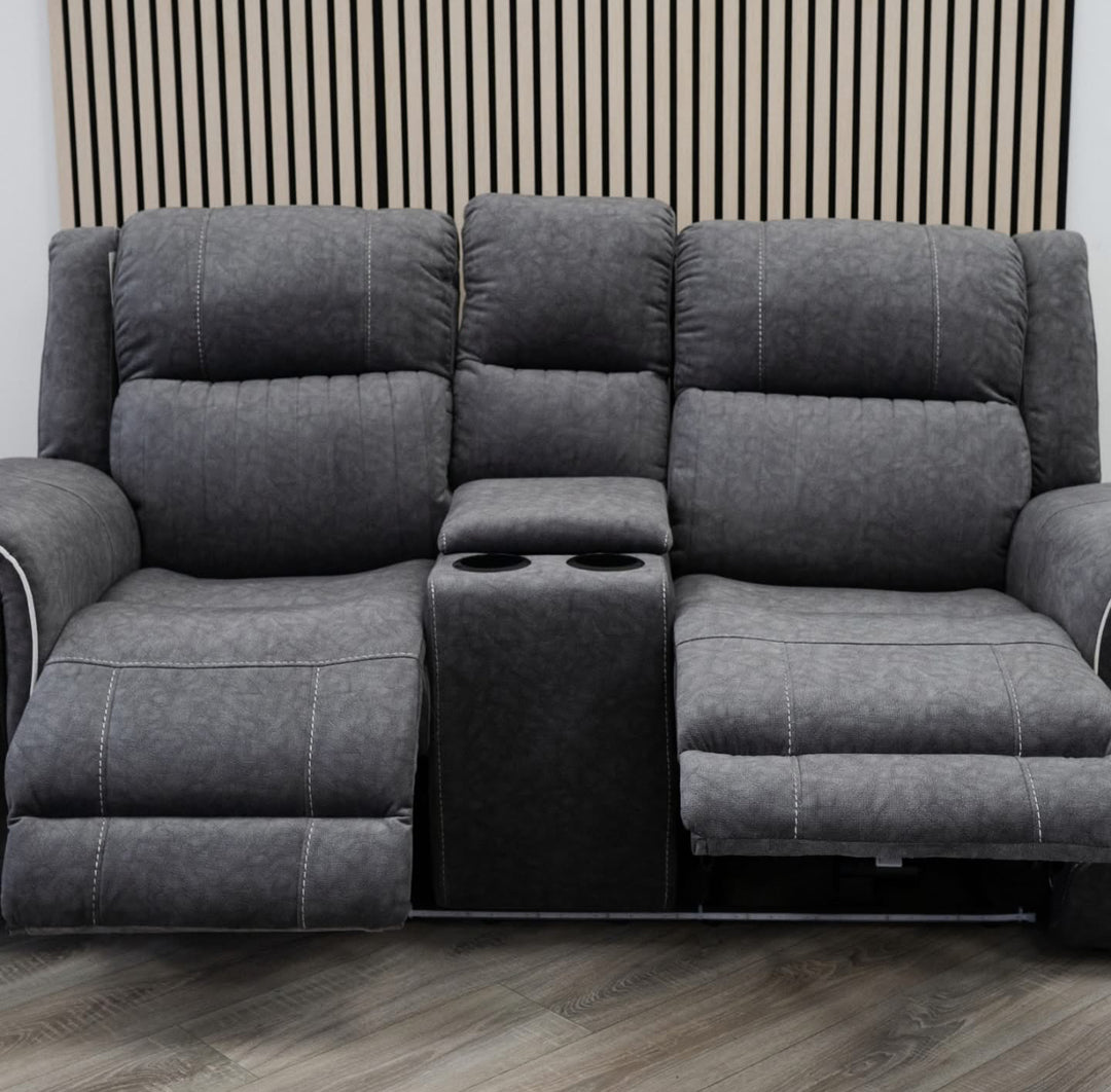 Gray sectional sofa with cup holders on a wooden floor.