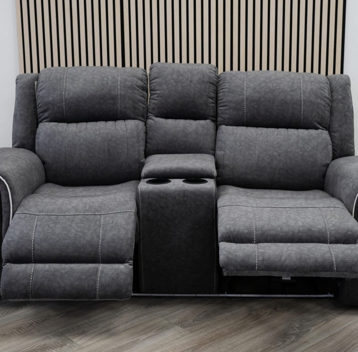 Gray sectional sofa with cup holders on a wooden floor.