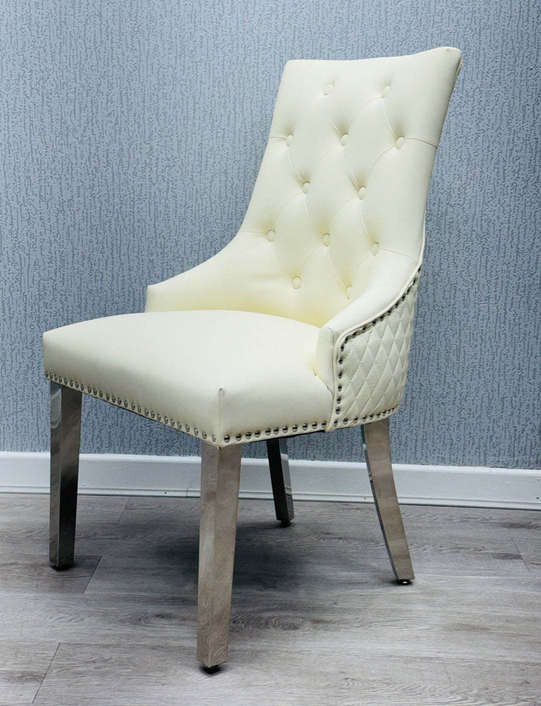  a cream color lion konker chair with chrome colour leg