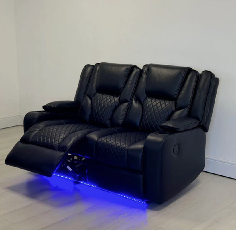 A black electric leather recliner sofa with a cup holder and illuminated by blue LED lights, set against a white background.