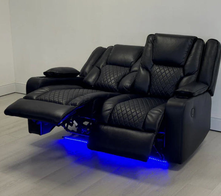 Black leather recliner chair with LED lighting on a wooden floor.