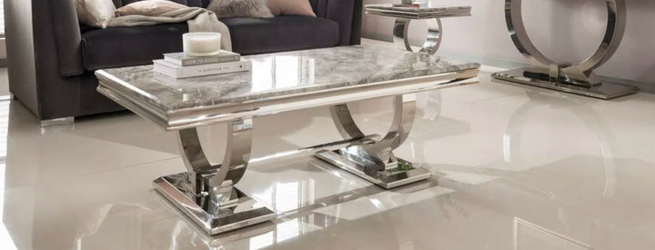 An elegant rectangular Arriana marble coffee table with a stainless steel double circular base, placed in a living room setting.
Grey Coffee table 
Black coffee table 
Cream coffee table 
White coffee table 
Beige coffee table 